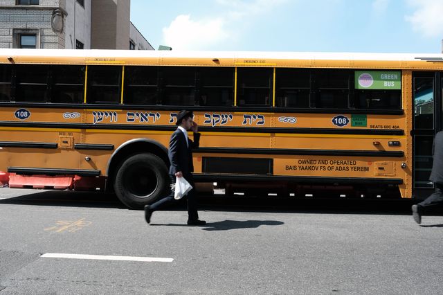 A yeshiva school bus drives through Borough Park, Brooklyn.
